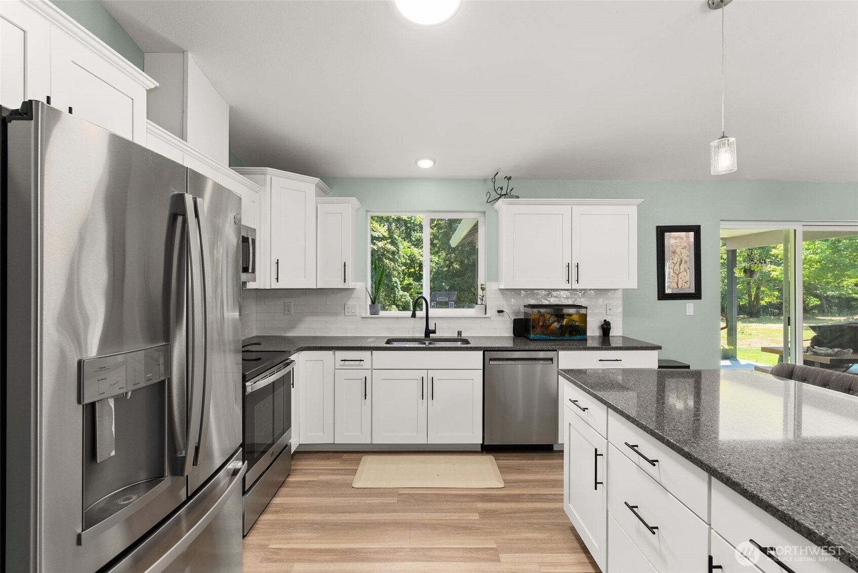 317 Cousins Road Chehalis, WA 98532 - Photo 11 of 40 a kitchen with granite countertop a sink stainless steel appliances and cabinets