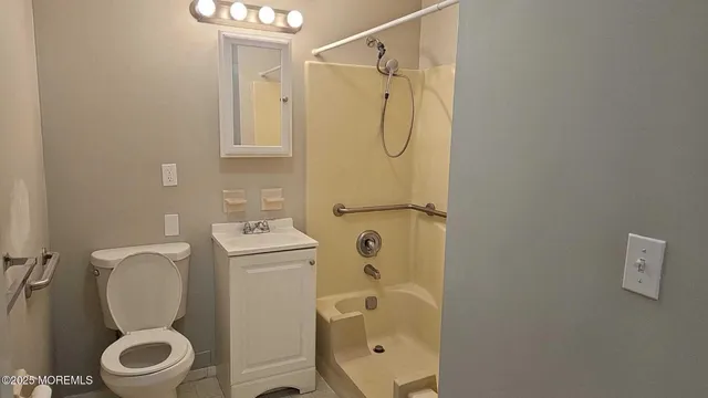 a bathroom with a toilet sink and shower