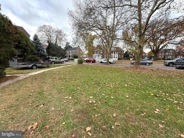 a view of yard with swimming pool and trees