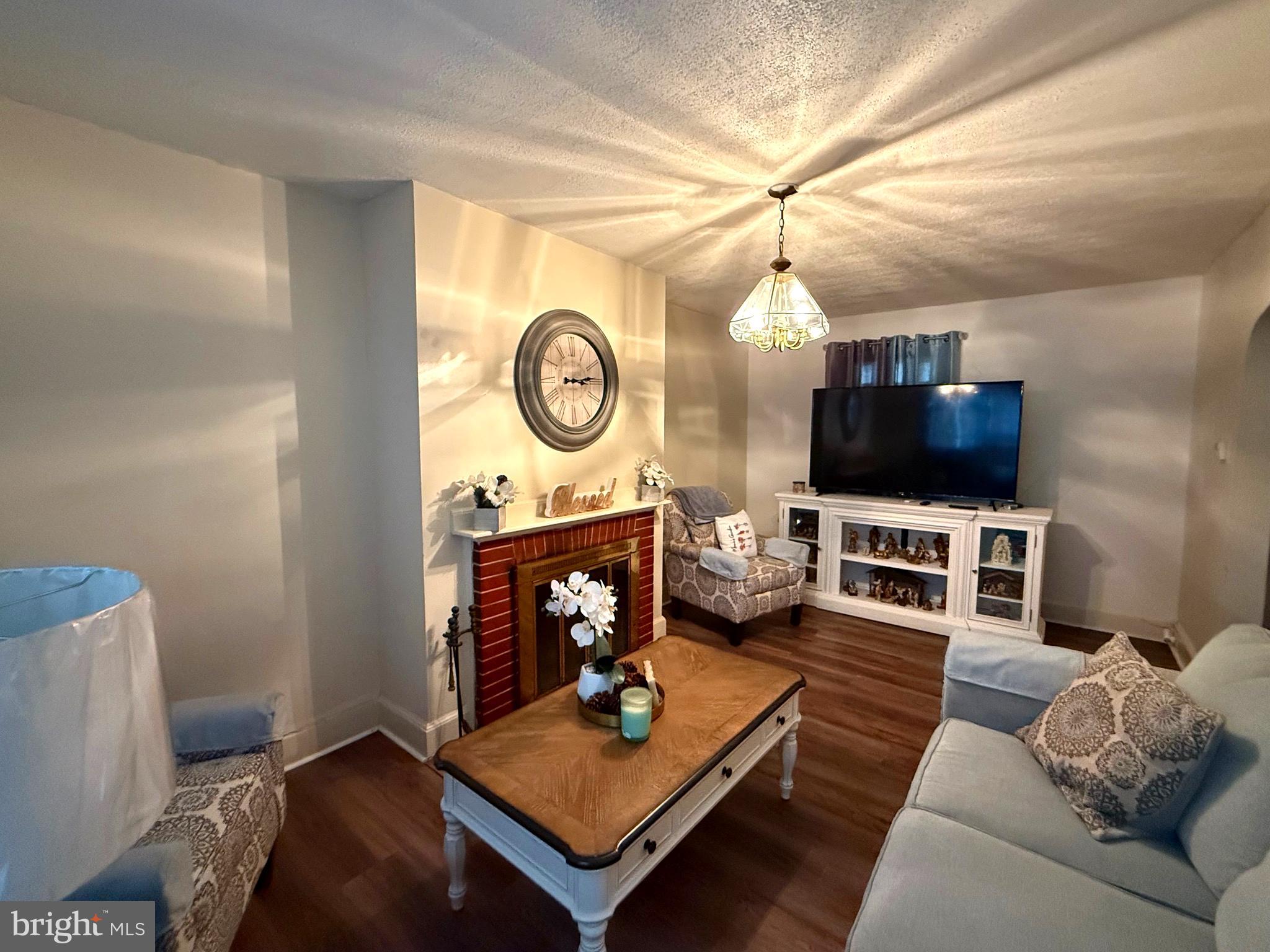 1623 Olympia Road Camden, NJ 08104 - Photo 3 of 23 a living room with furniture a flat screen tv and a fireplace