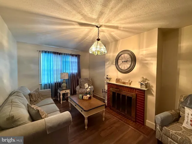 a living room with furniture a clock and a fireplace
