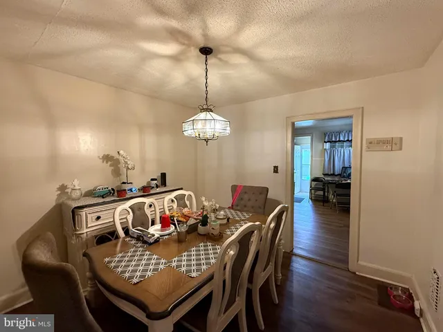 a view of a dining room with furniture wooden floor and chandelier