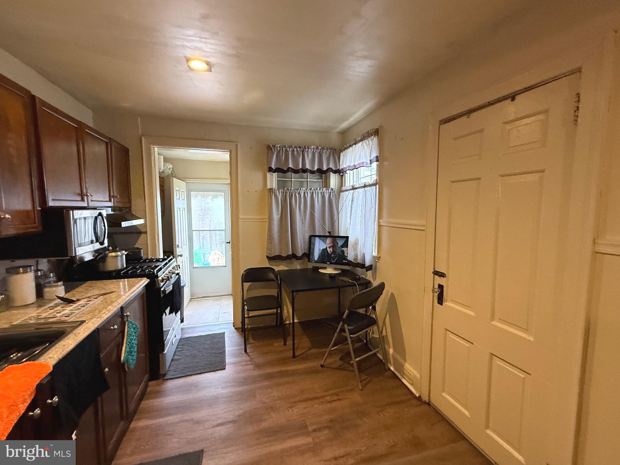 1623 Olympia Road Camden, NJ 08104 - Photo 7 of 23 a kitchen with sink cabinets and wooden floor