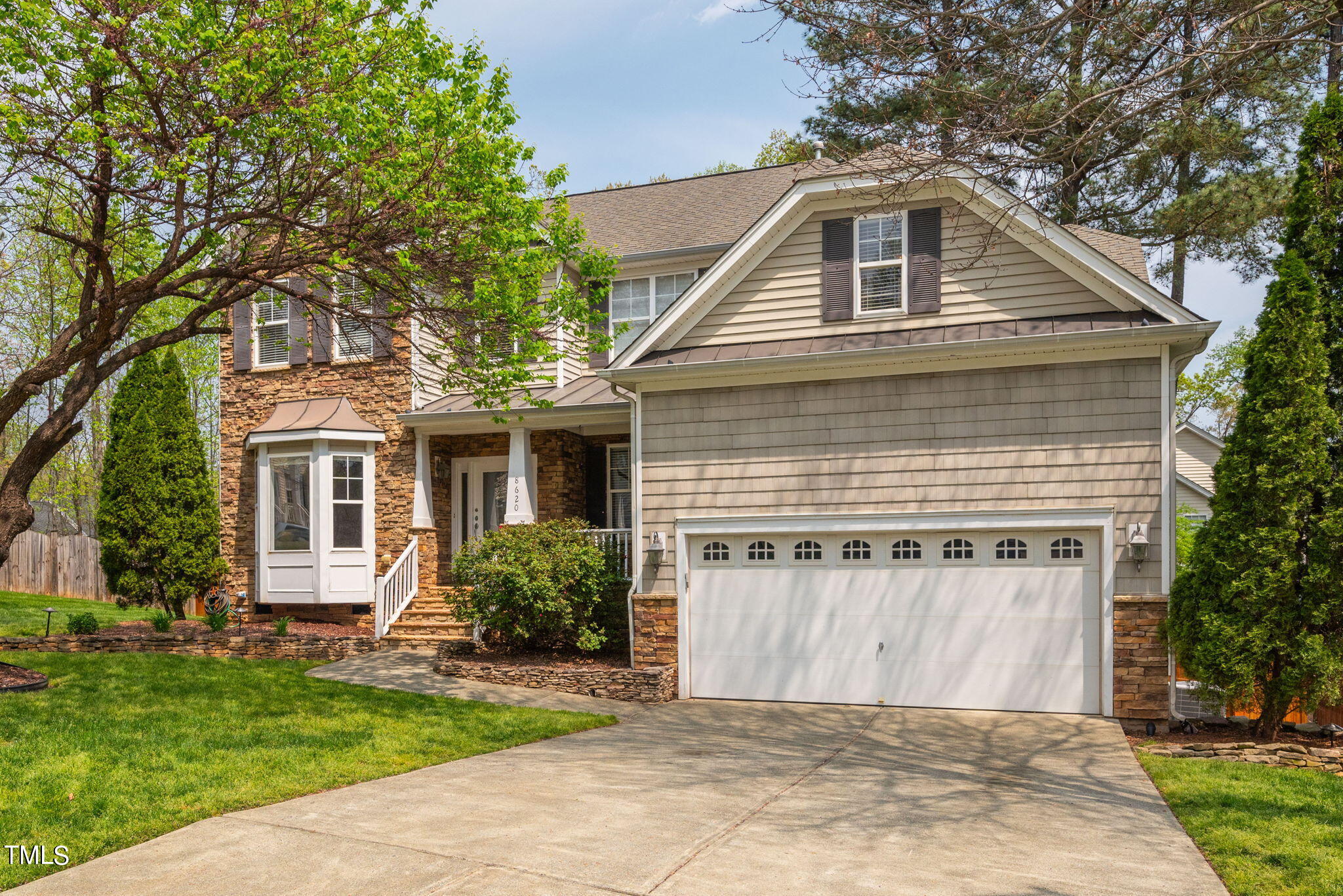 8620 Benzinger Drive Raleigh, NC 27613 - Photo 1 of 51 a front view of a house with a garden
