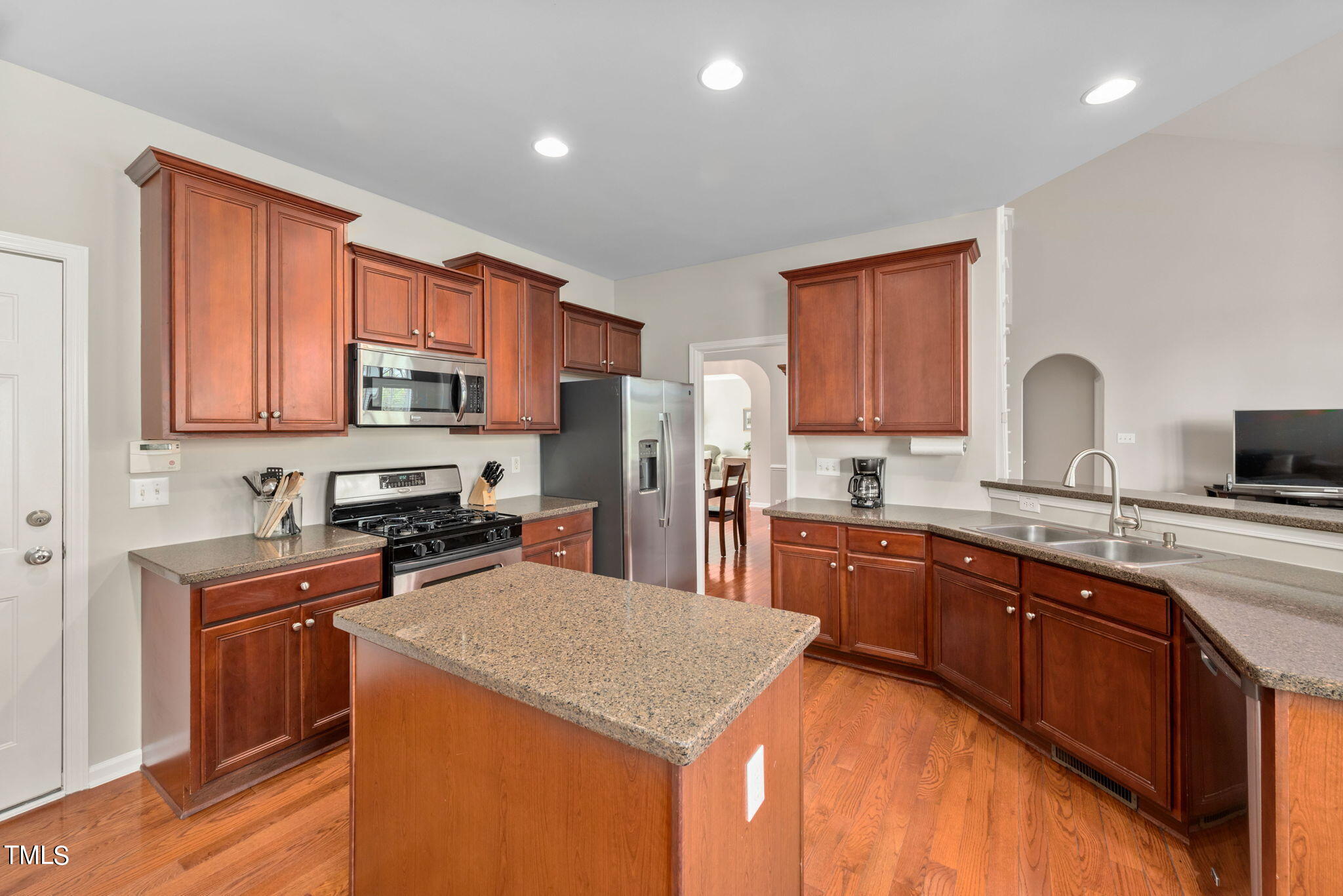 8620 Benzinger Drive Raleigh, NC 27613 - Photo 12 of 51 a kitchen with stainless steel appliances granite countertop a sink stove refrigerator and cabinets