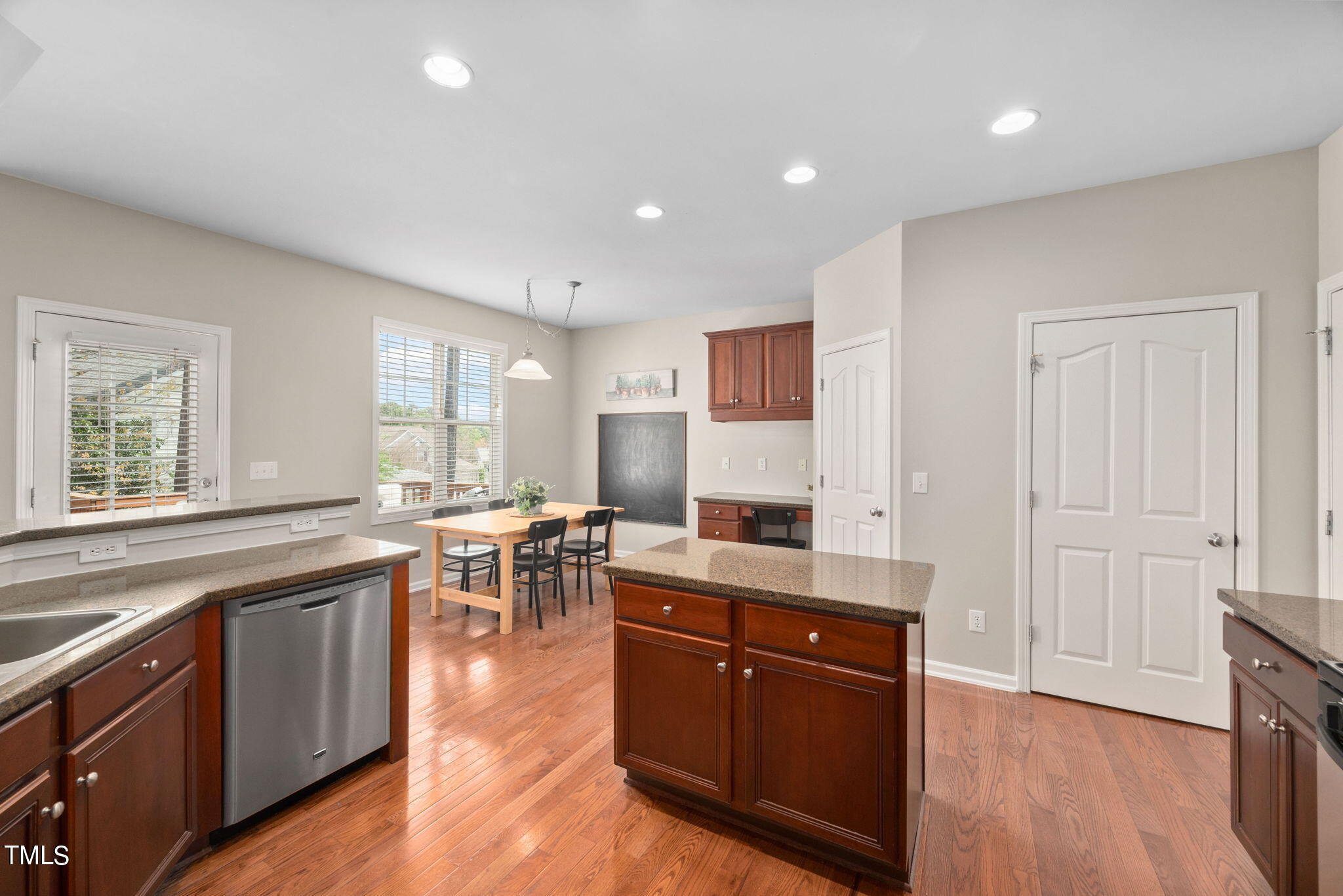 8620 Benzinger Drive Raleigh, NC 27613 - Photo 14 of 51 a large kitchen with stainless steel appliances granite countertop a stove and a sink