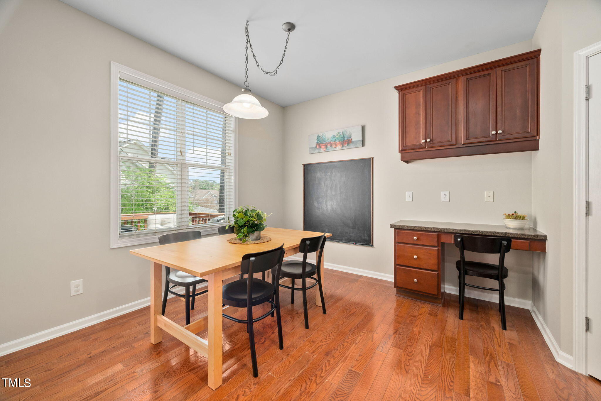 8620 Benzinger Drive Raleigh, NC 27613 - Photo 15 of 51 a view of a dining room with furniture window and wooden floor