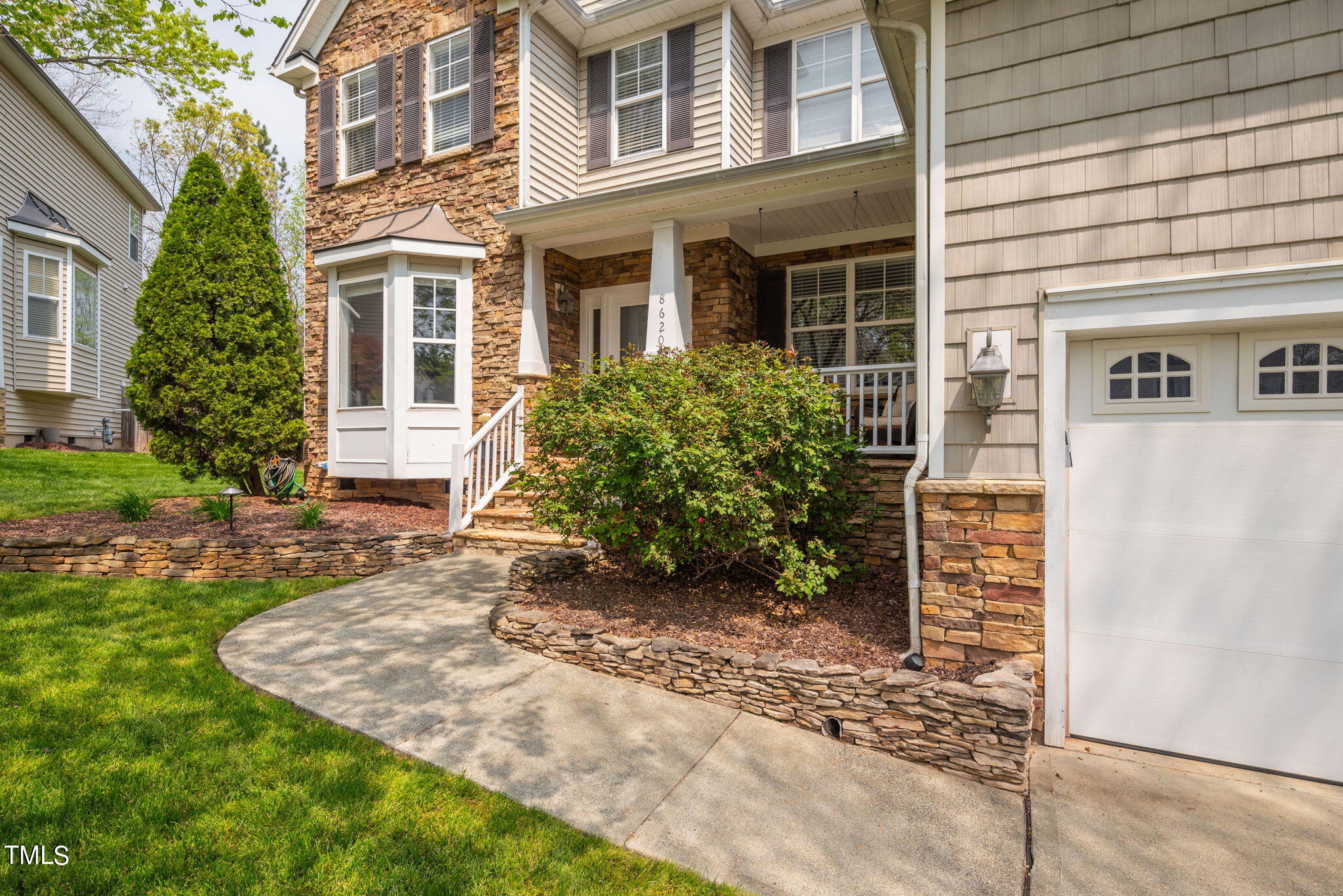 8620 Benzinger Drive Raleigh, NC 27613 - Photo 2 of 51 a view of a house with brick walls and a yard with plants