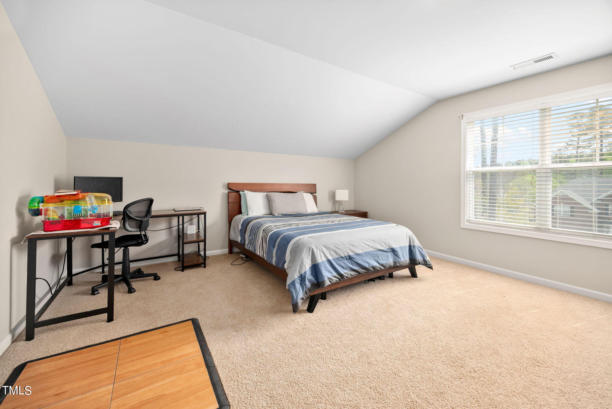 8620 Benzinger Drive Raleigh, NC 27613 - Photo 22 of 51 a bedroom with a bed a table and a large window