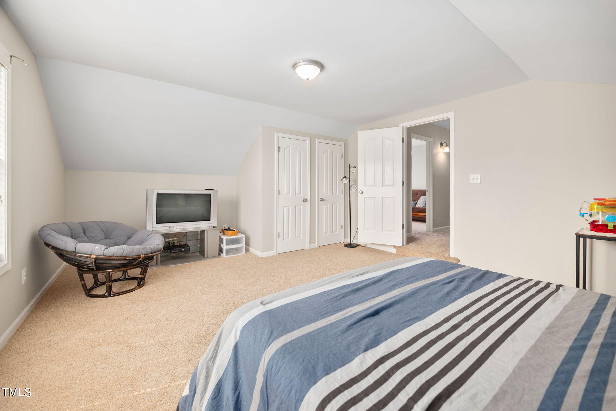 8620 Benzinger Drive Raleigh, NC 27613 - Photo 23 of 51 a bedroom with a bed and a tv on table