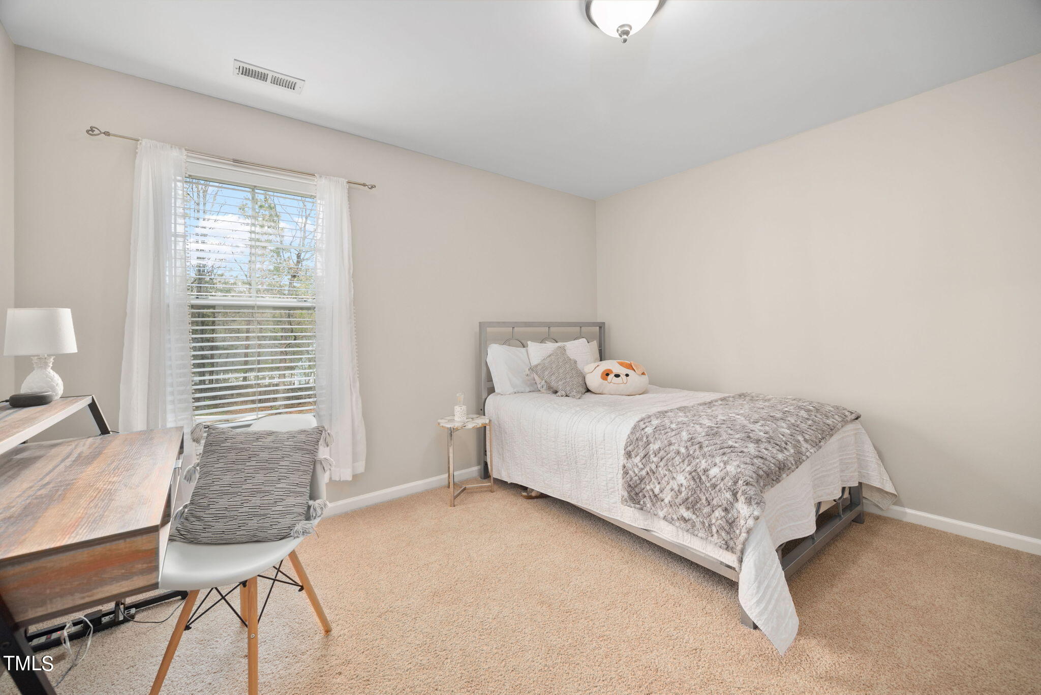 8620 Benzinger Drive Raleigh, NC 27613 - Photo 29 of 51 a bedroom with a bed and a table in it