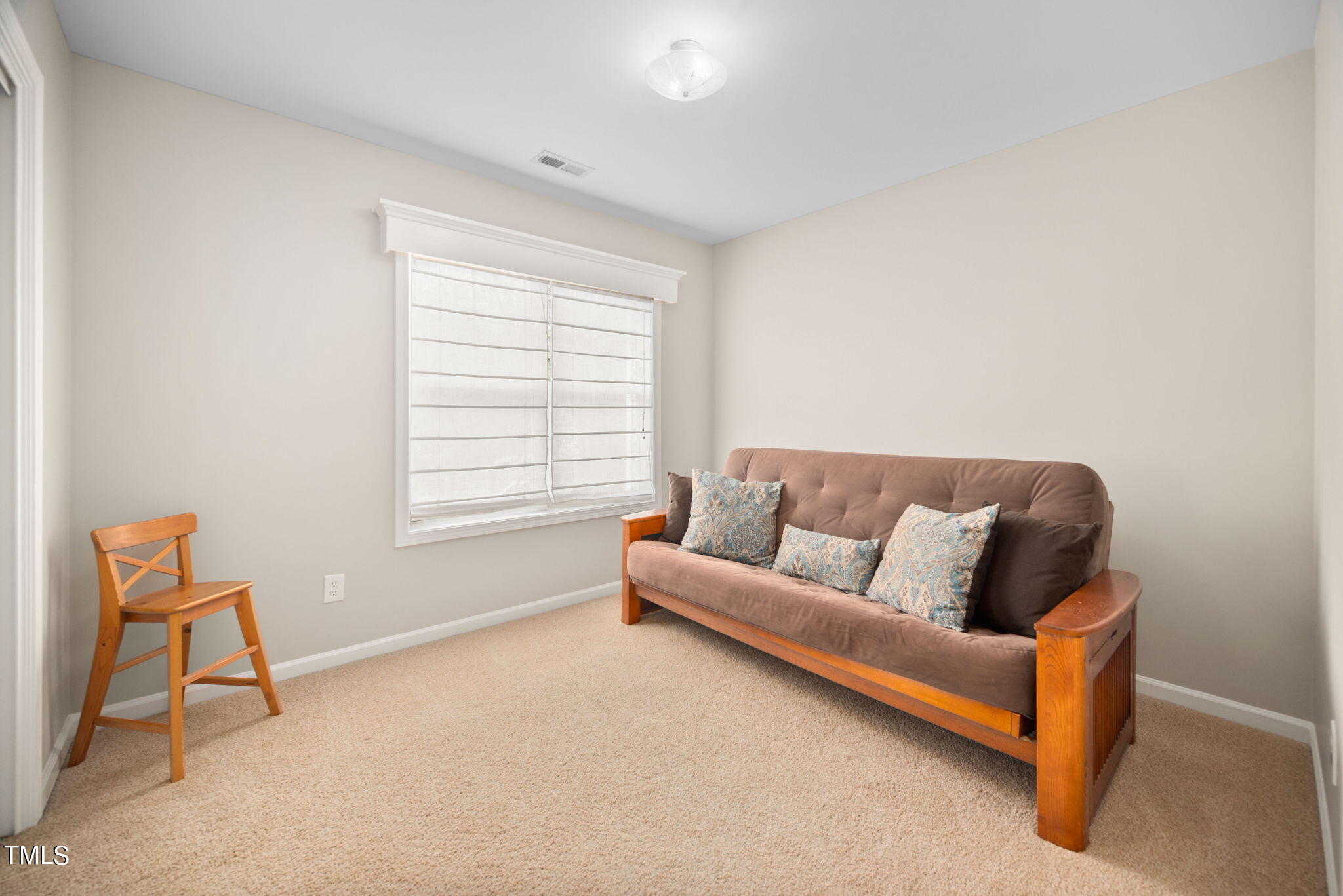 8620 Benzinger Drive Raleigh, NC 27613 - Photo 30 of 51 a living room with furniture and a window