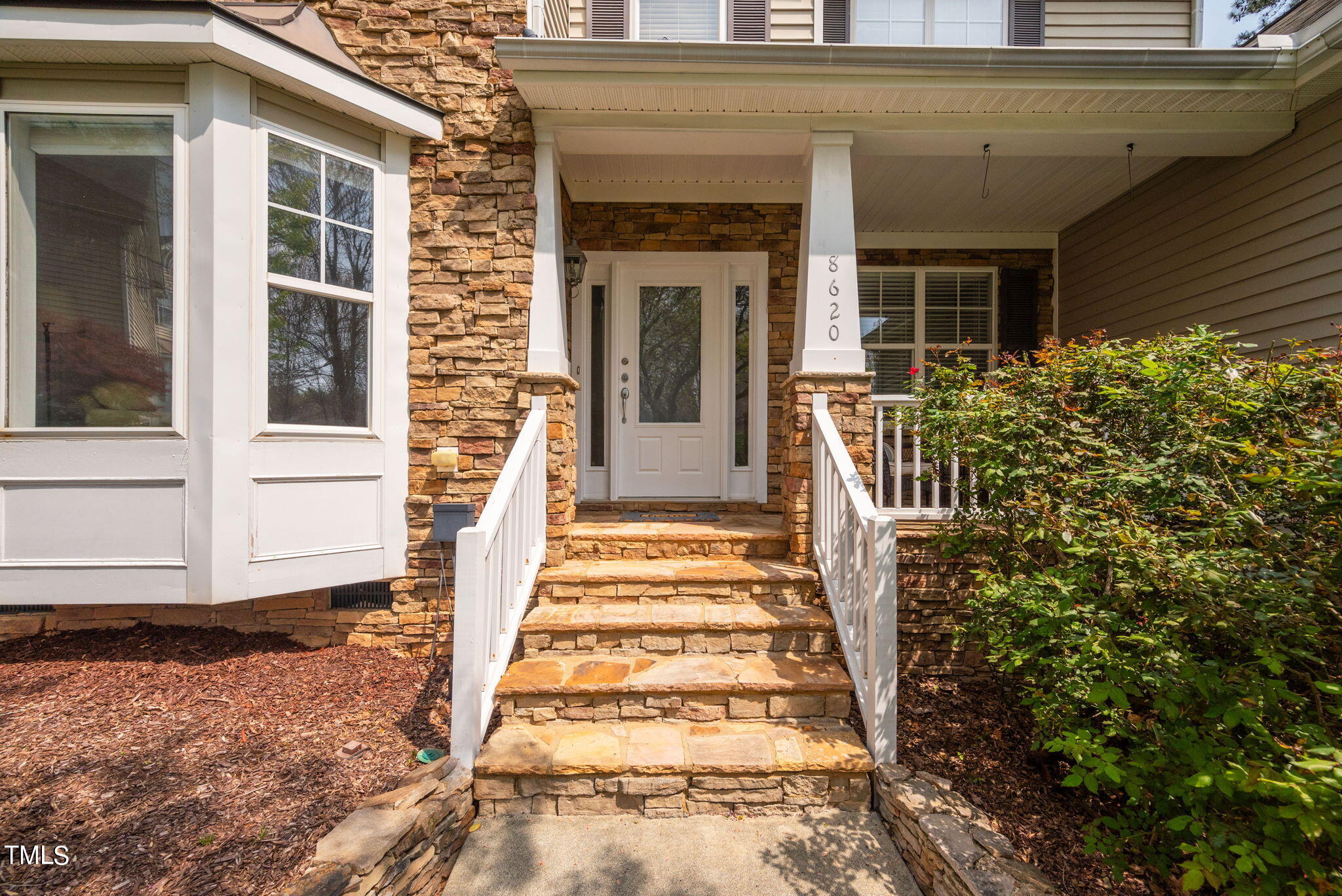 8620 Benzinger Drive Raleigh, NC 27613 - Photo 3 of 51 a front view of a house with a garden