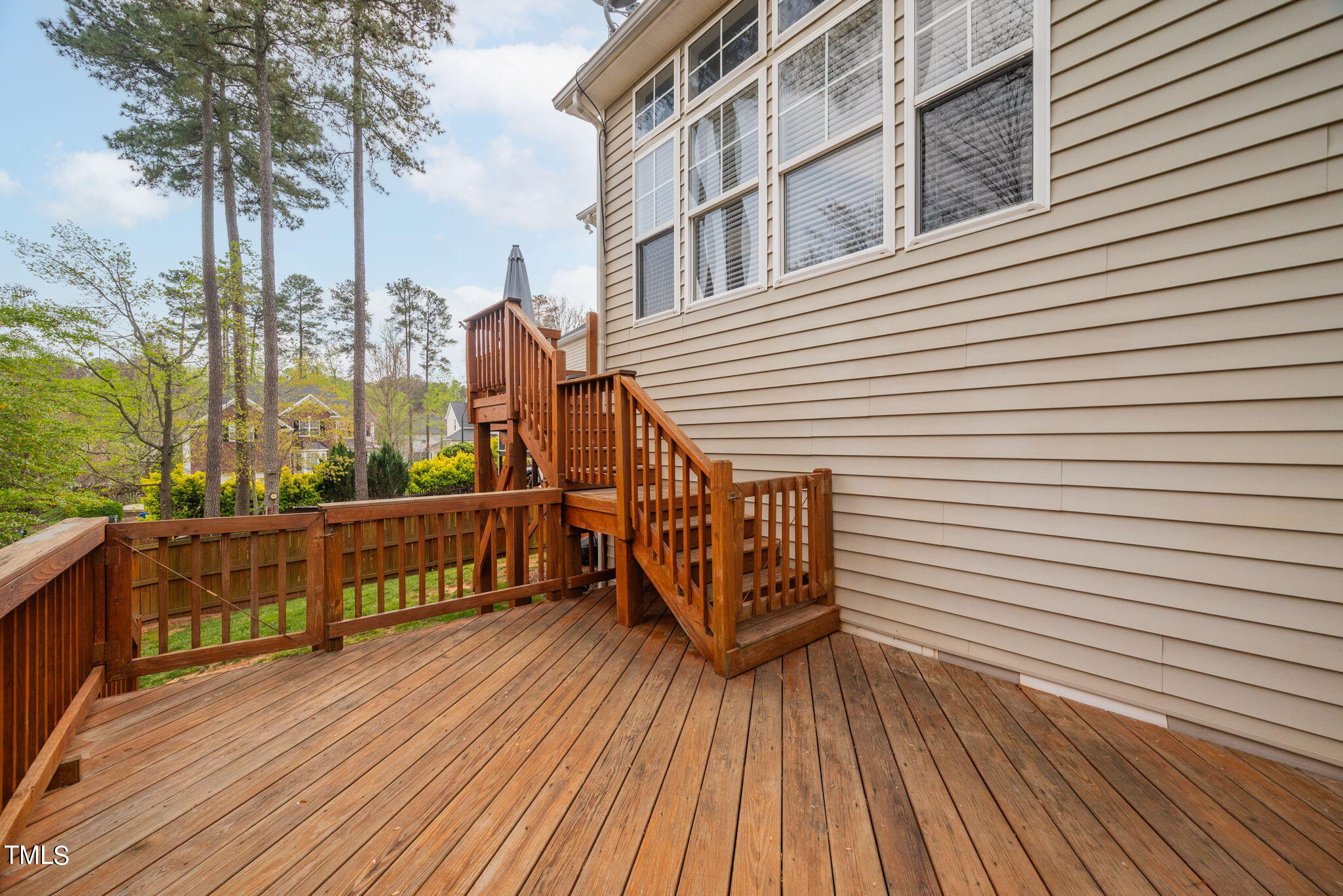 8620 Benzinger Drive Raleigh, NC 27613 - Photo 35 of 51 a view of a wooden deck with a barbeque