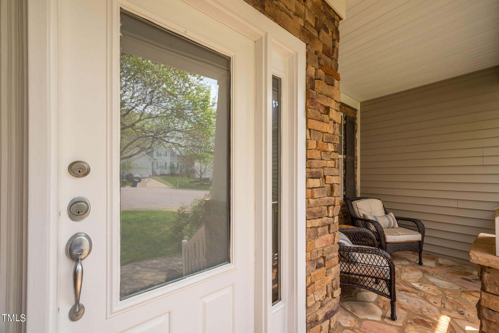8620 Benzinger Drive Raleigh, NC 27613 - Photo 4 of 51 a view of a balcony with chair and glass door
