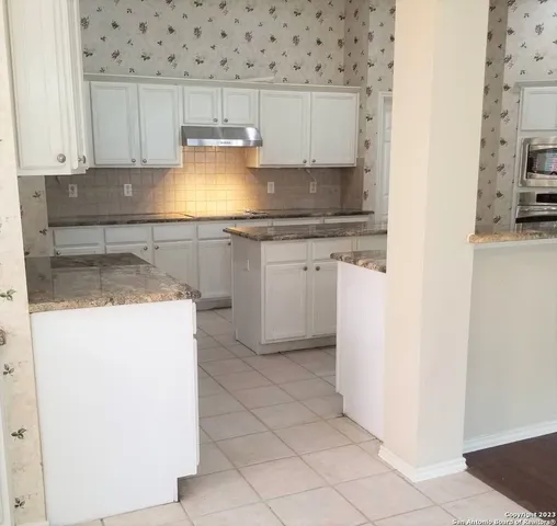 a kitchen with a sink and cabinets