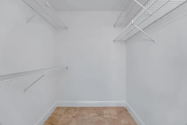 a bathroom with a granite countertop sink and a toilet