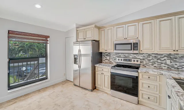 a view of a chandelier fan and window