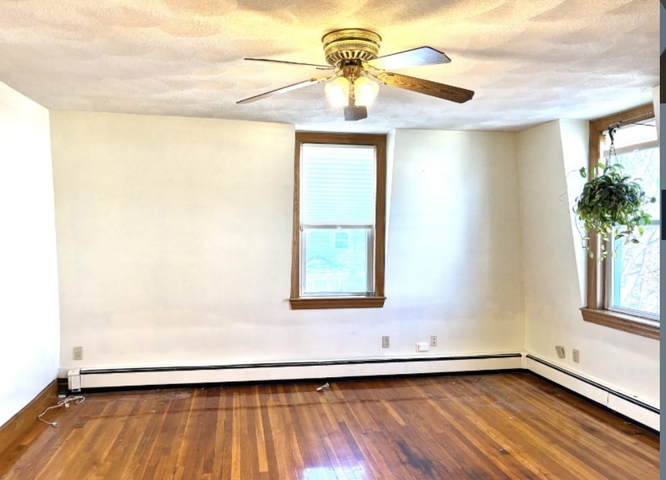 55 Port Norfolk Street, Unit 3 Boston, MA 02122 - Photo 7 of 15 a view of a room with wooden floor and window