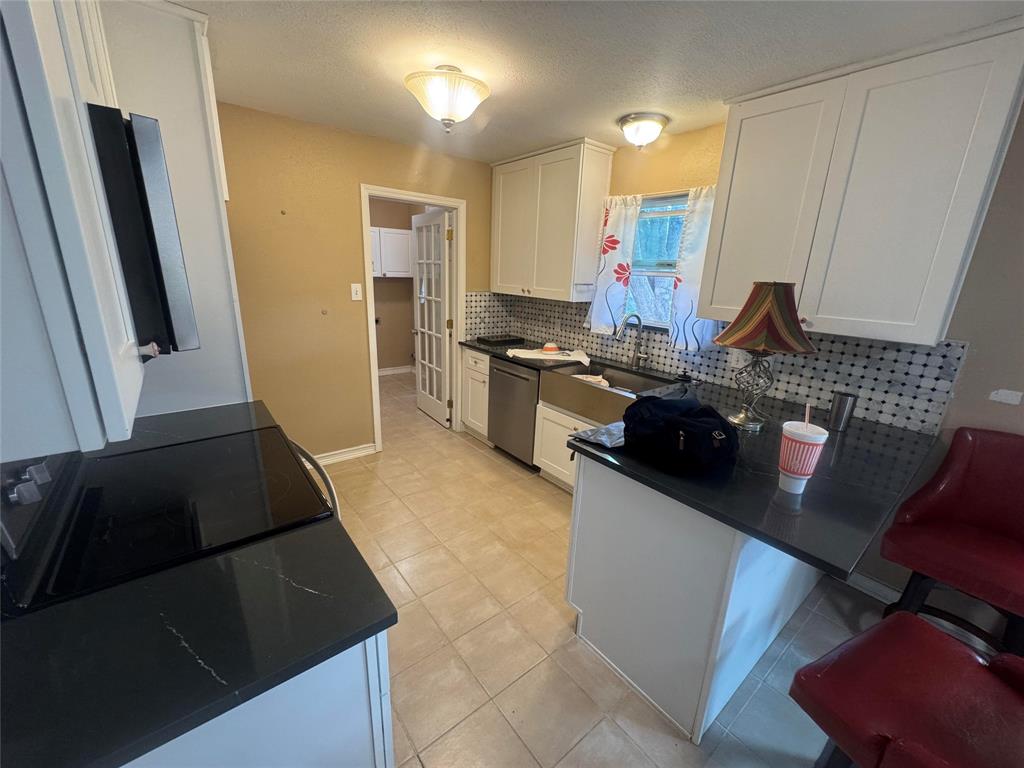 4649 Misty Ridge Drive Fort Worth, TX 76137 - Photo 22 of 25 a kitchen with a sink and a stove top oven