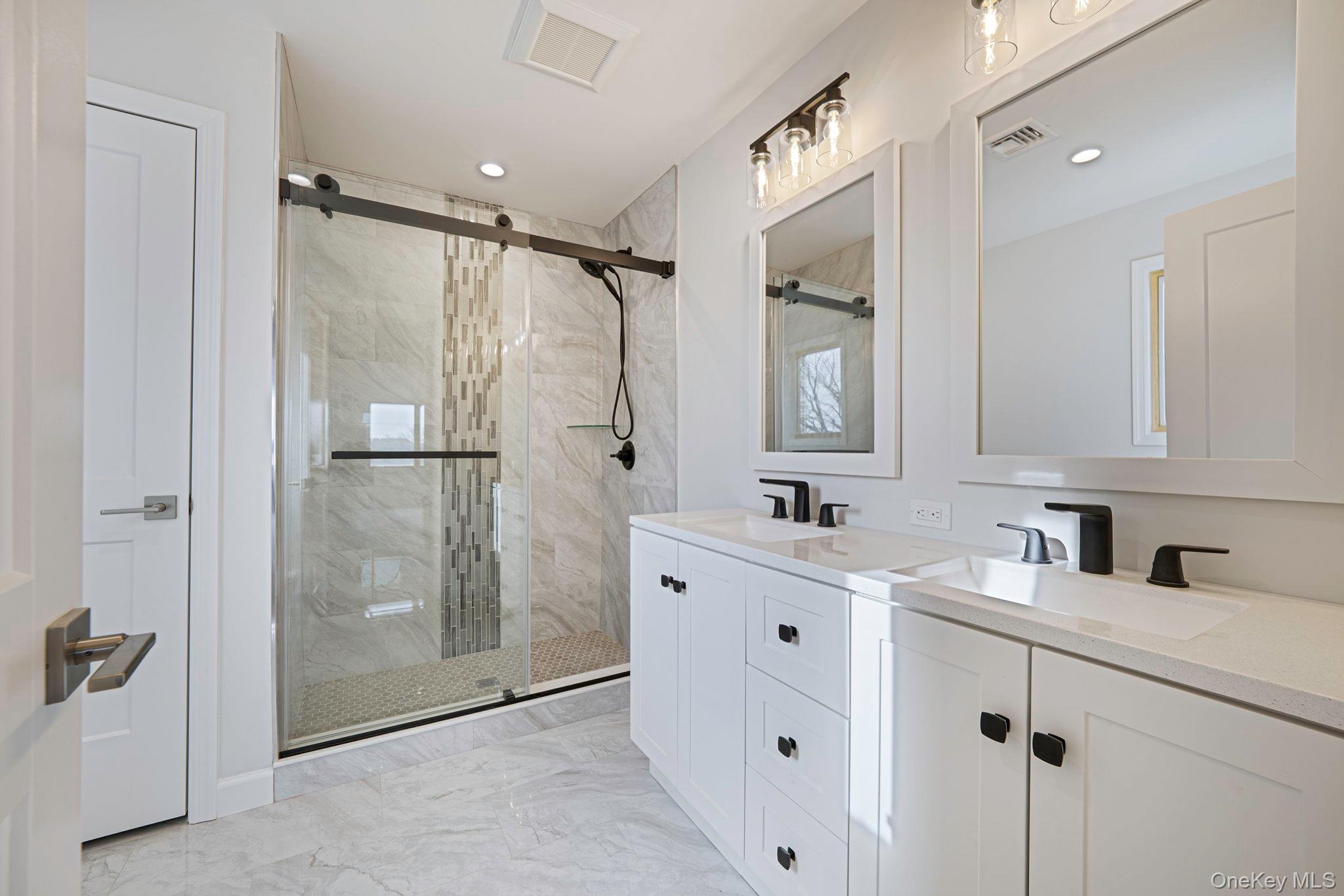 115 Riviera Parkway Lindenhurst, NY 11757 - Photo 12 of 33 Full bathroom featuring double vanity, light marble finish floors, a marble finish shower, and recessed lighting