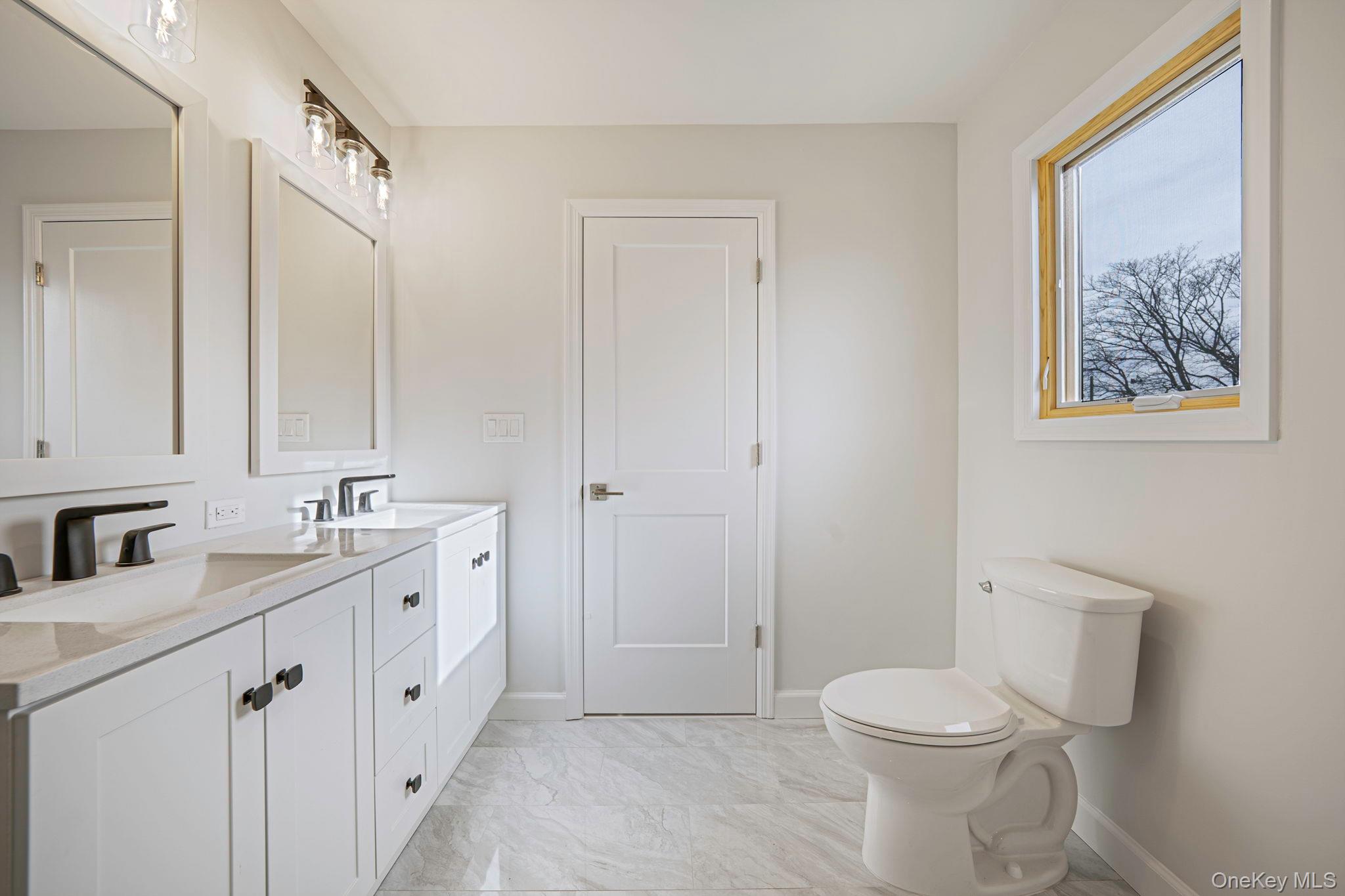 115 Riviera Parkway Lindenhurst, NY 11757 - Photo 13 of 33 Full bath featuring double vanity and light marble finish floors