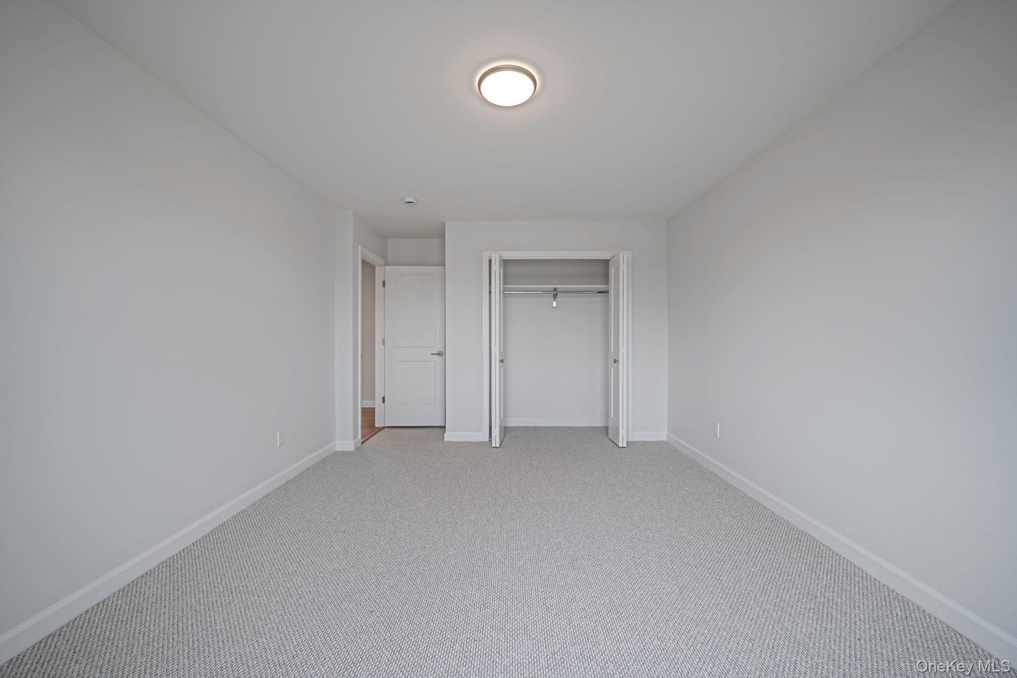 115 Riviera Parkway Lindenhurst, NY 11757 - Photo 16 of 33 Unfurnished bedroom with carpet floors and a closet