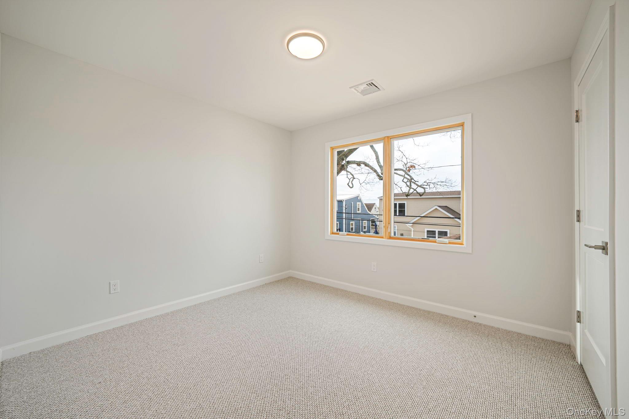 115 Riviera Parkway Lindenhurst, NY 11757 - Photo 17 of 33 Carpeted spare room with baseboards