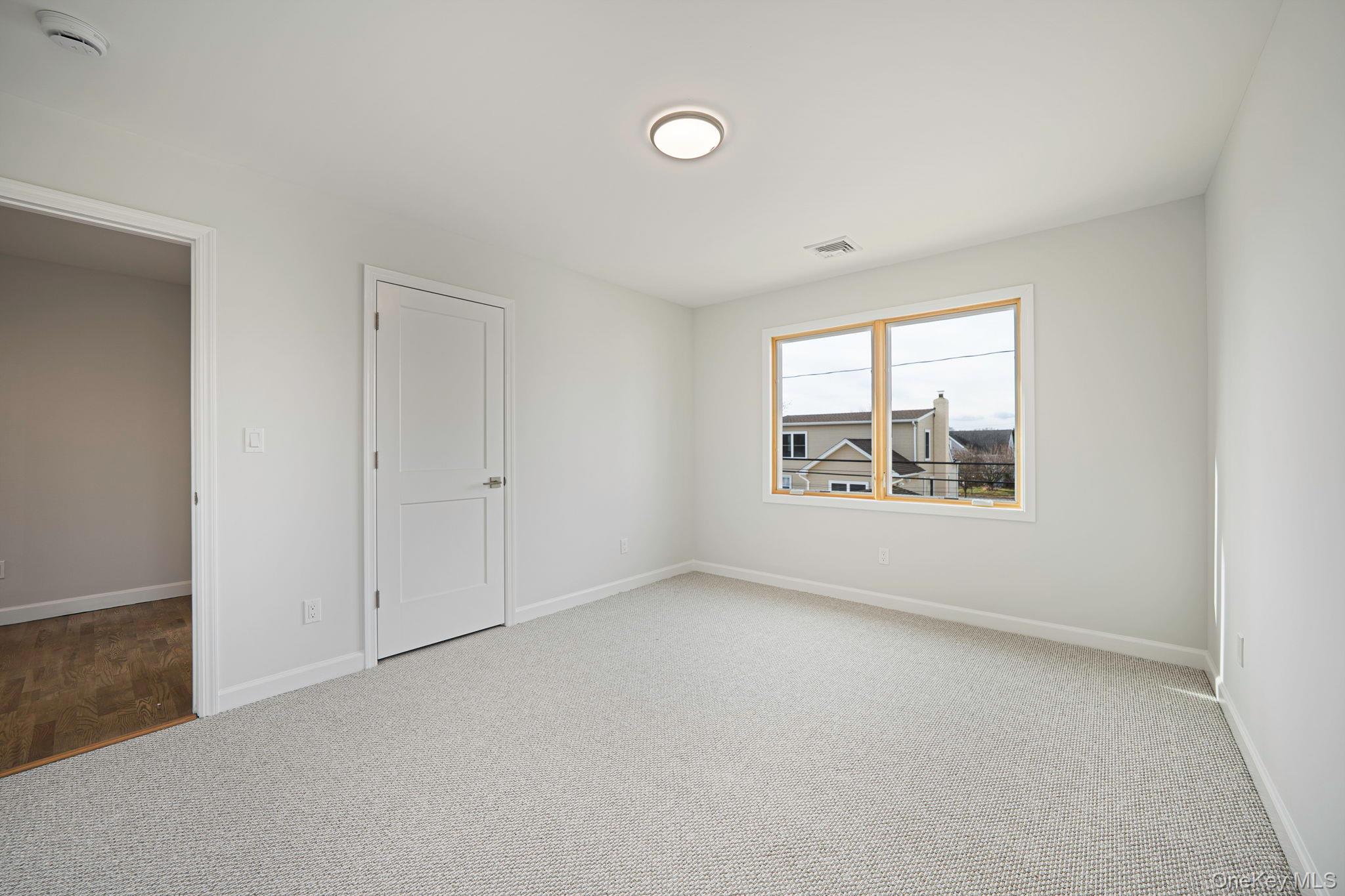 115 Riviera Parkway Lindenhurst, NY 11757 - Photo 21 of 33 Carpeted empty room with baseboards