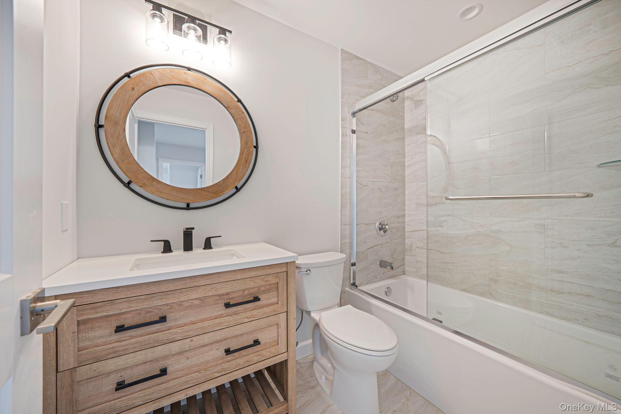 115 Riviera Parkway Lindenhurst, NY 11757 - Photo 22 of 33 Bathroom featuring vanity and combined bath / shower with glass door