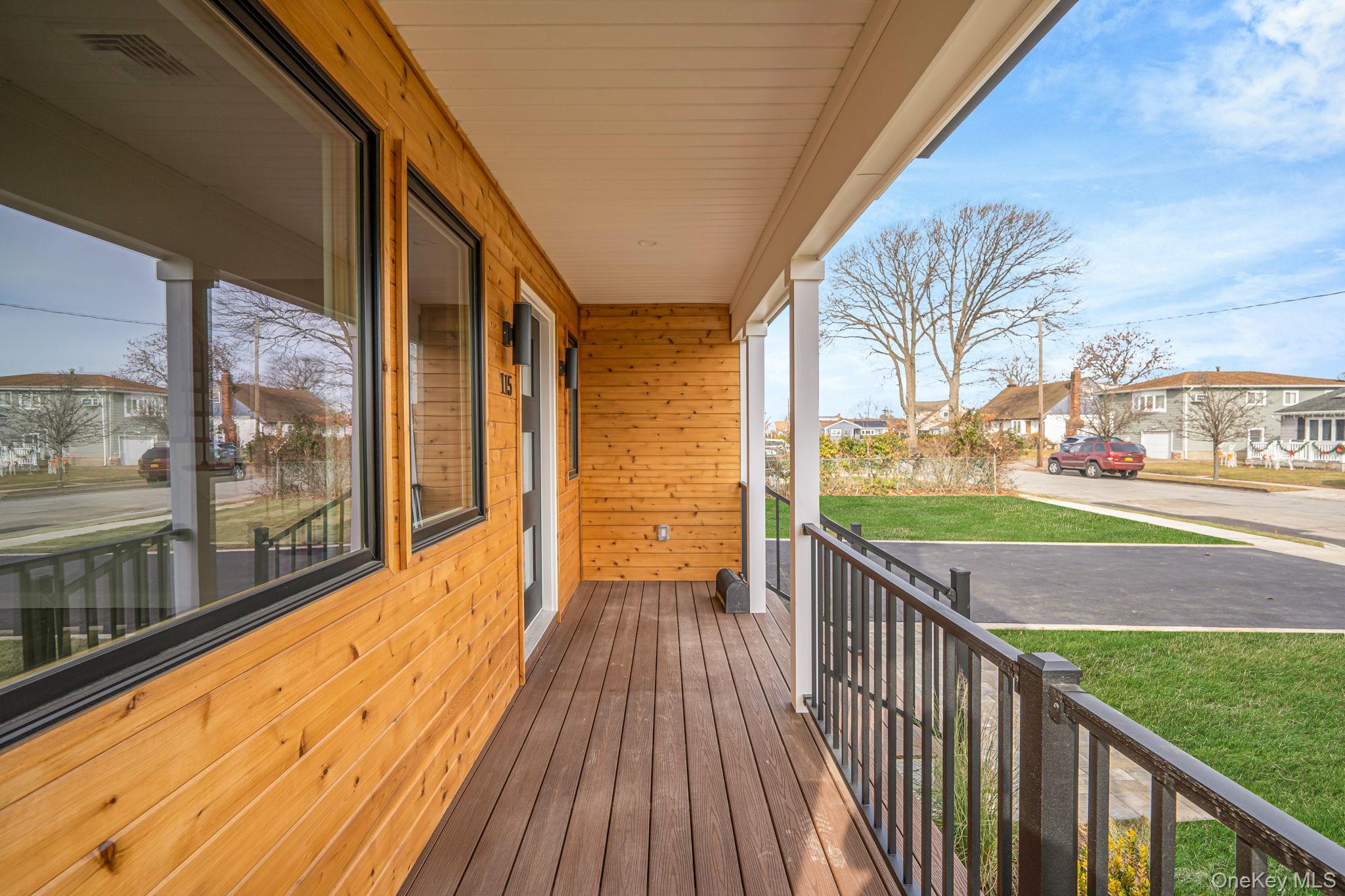 115 Riviera Parkway Lindenhurst, NY 11757 - Photo 3 of 33 Porch featuring a residential view and a lawn