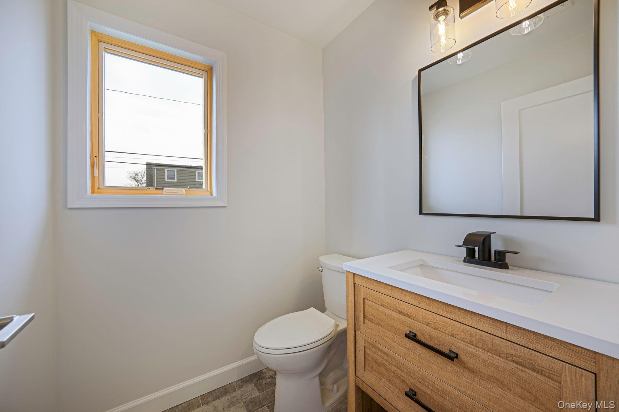 115 Riviera Parkway Lindenhurst, NY 11757 - Photo 33 of 33 Bathroom with vanity and baseboards