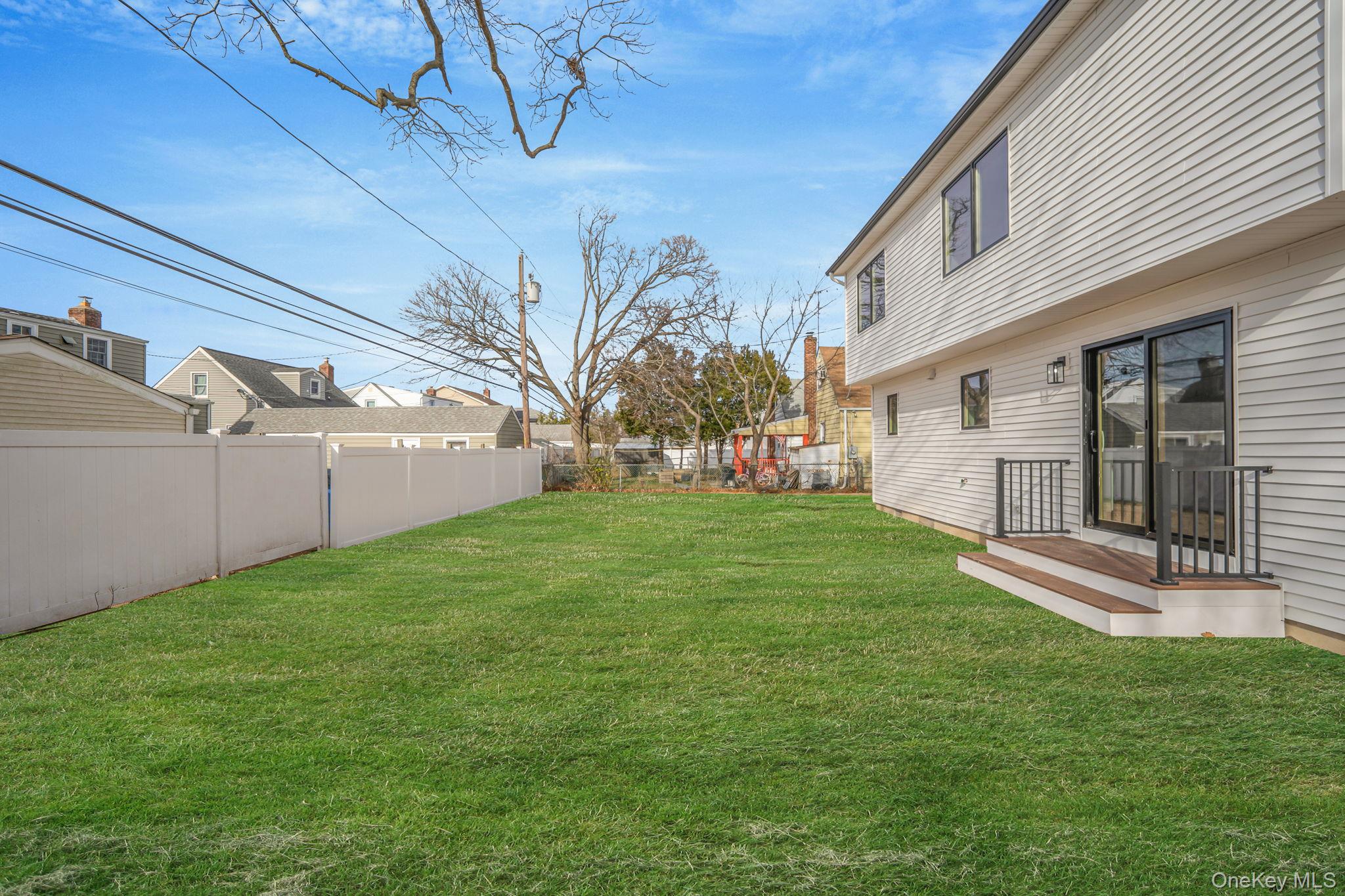 115 Riviera Parkway Lindenhurst, NY 11757 - Photo 6 of 33 Fenced backyard featuring a deck