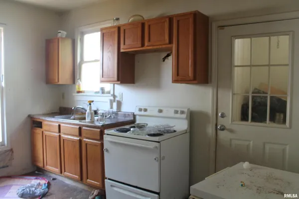 a kitchen with a sink stove and cabinets