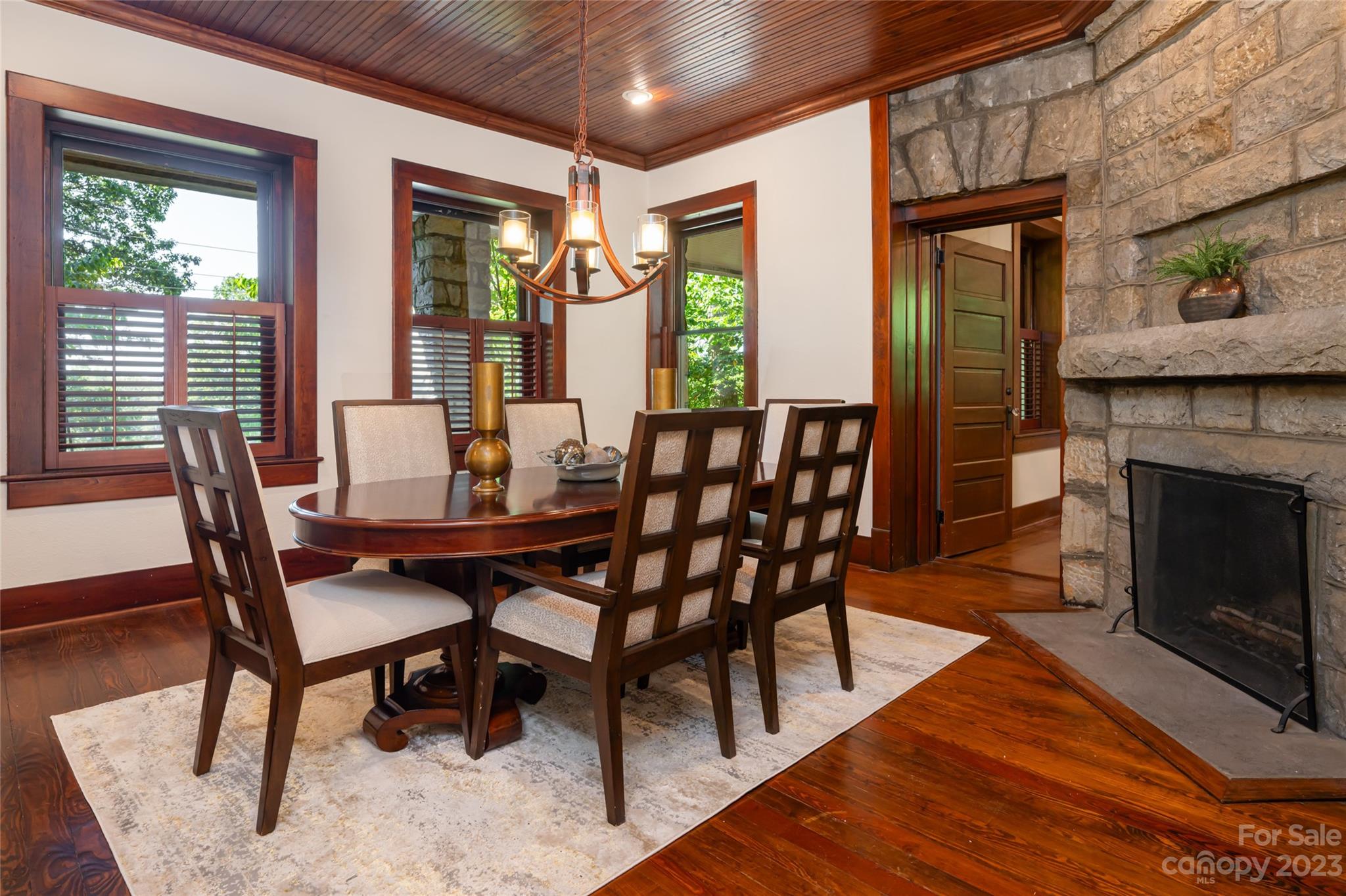 27 Edgewood Road Asheville, NC 28804 - Photo 13 of 48 a dining room with furniture a fireplace and wooden floor