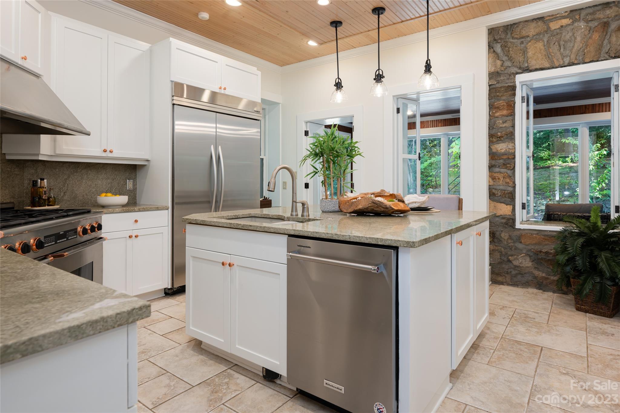 27 Edgewood Road Asheville, NC 28804 - Photo 15 of 48 a kitchen with stainless steel appliances granite countertop a sink stove and refrigerator