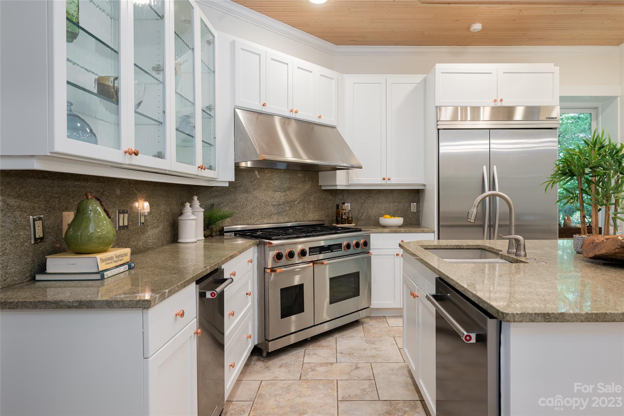 27 Edgewood Road Asheville, NC 28804 - Photo 17 of 48 a kitchen with stainless steel appliances granite countertop a sink stove and cabinets