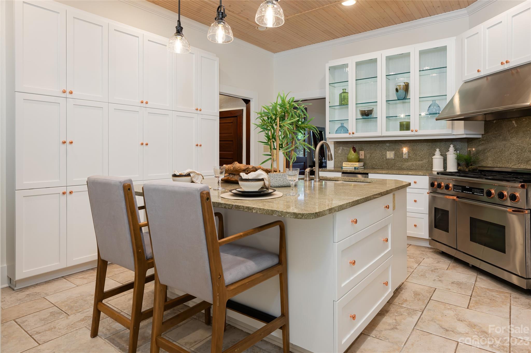 27 Edgewood Road Asheville, NC 28804 - Photo 18 of 48 a kitchen with stainless steel appliances kitchen island granite countertop a table chairs stove and cabinets