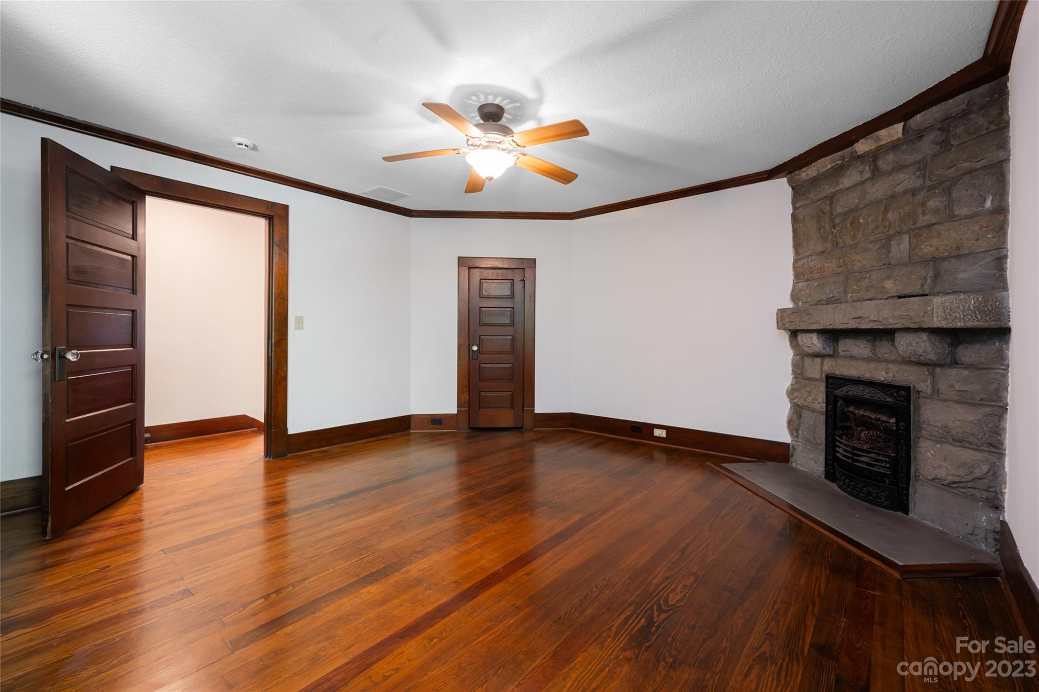 27 Edgewood Road Asheville, NC 28804 - Photo 34 of 48 an empty room with wooden floor fireplace and windows