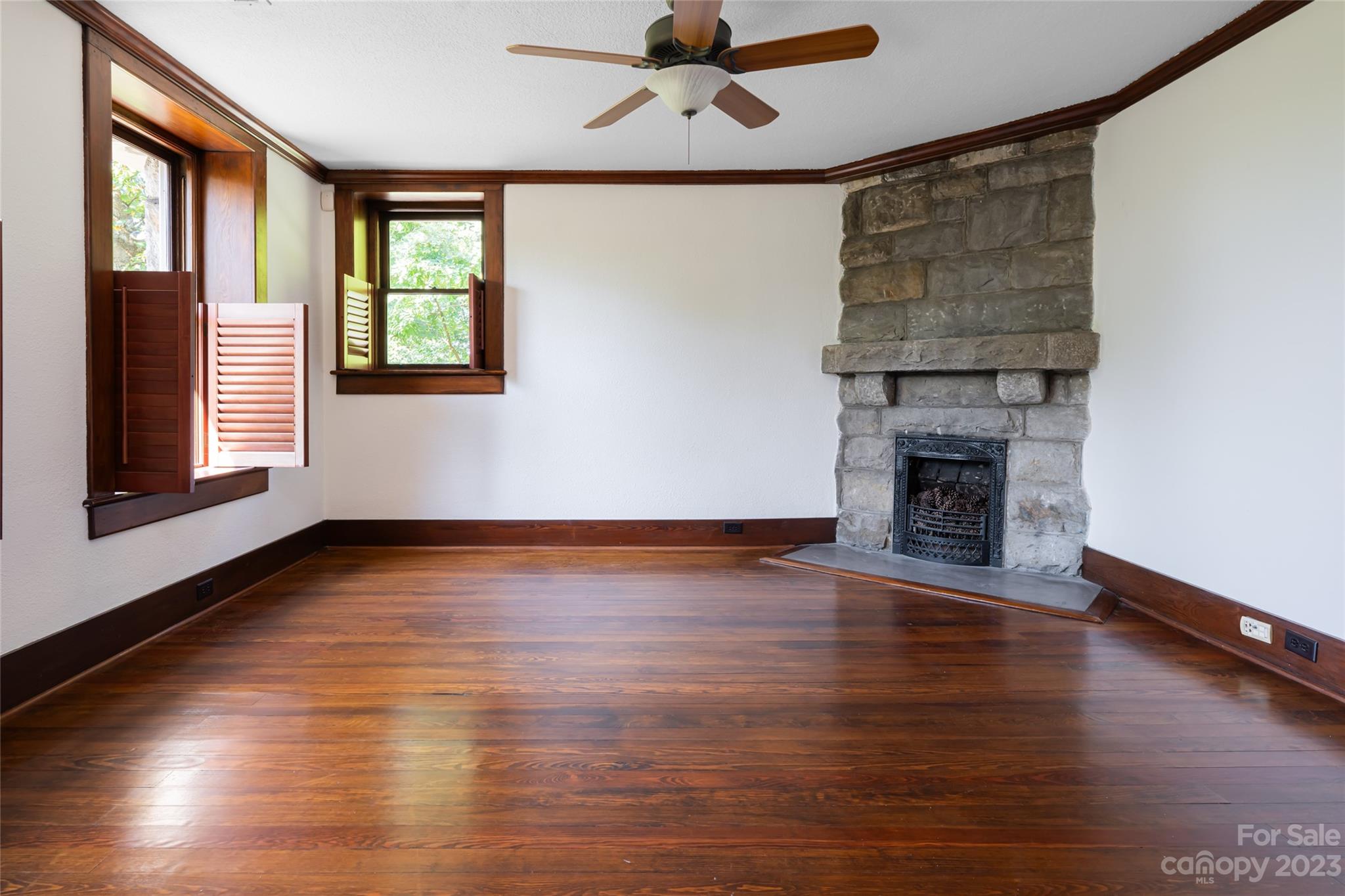 27 Edgewood Road Asheville, NC 28804 - Photo 36 of 48 an empty room with wooden floor fireplace and windows
