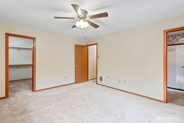 an empty room with a ceiling fan
