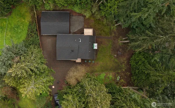 an aerial view of a house with a yard