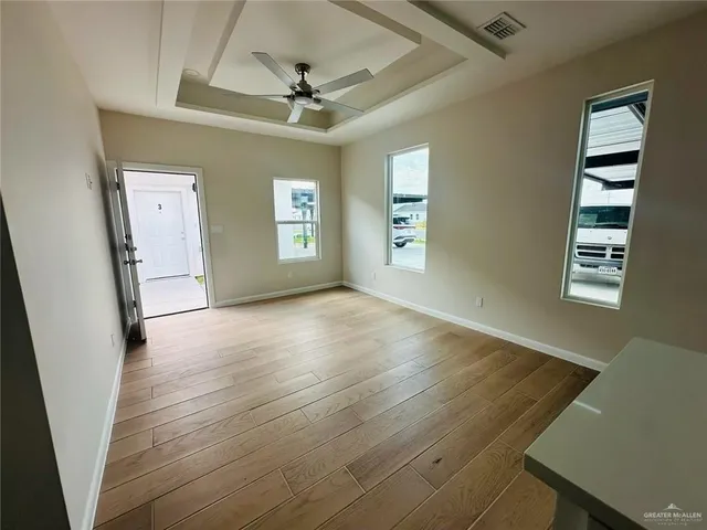 wooden floor in an empty room with a window