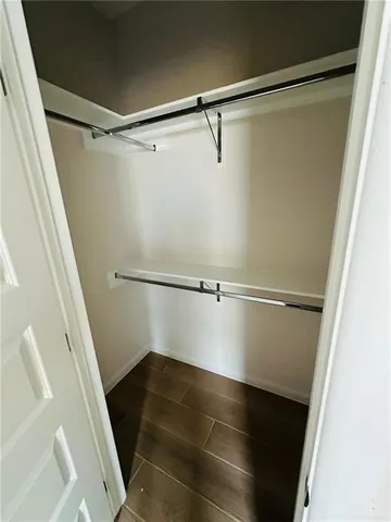 a view of walk in closet with empty racks