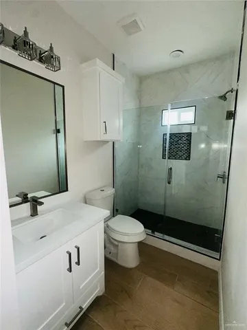 a bathroom with a sink toilet and shower