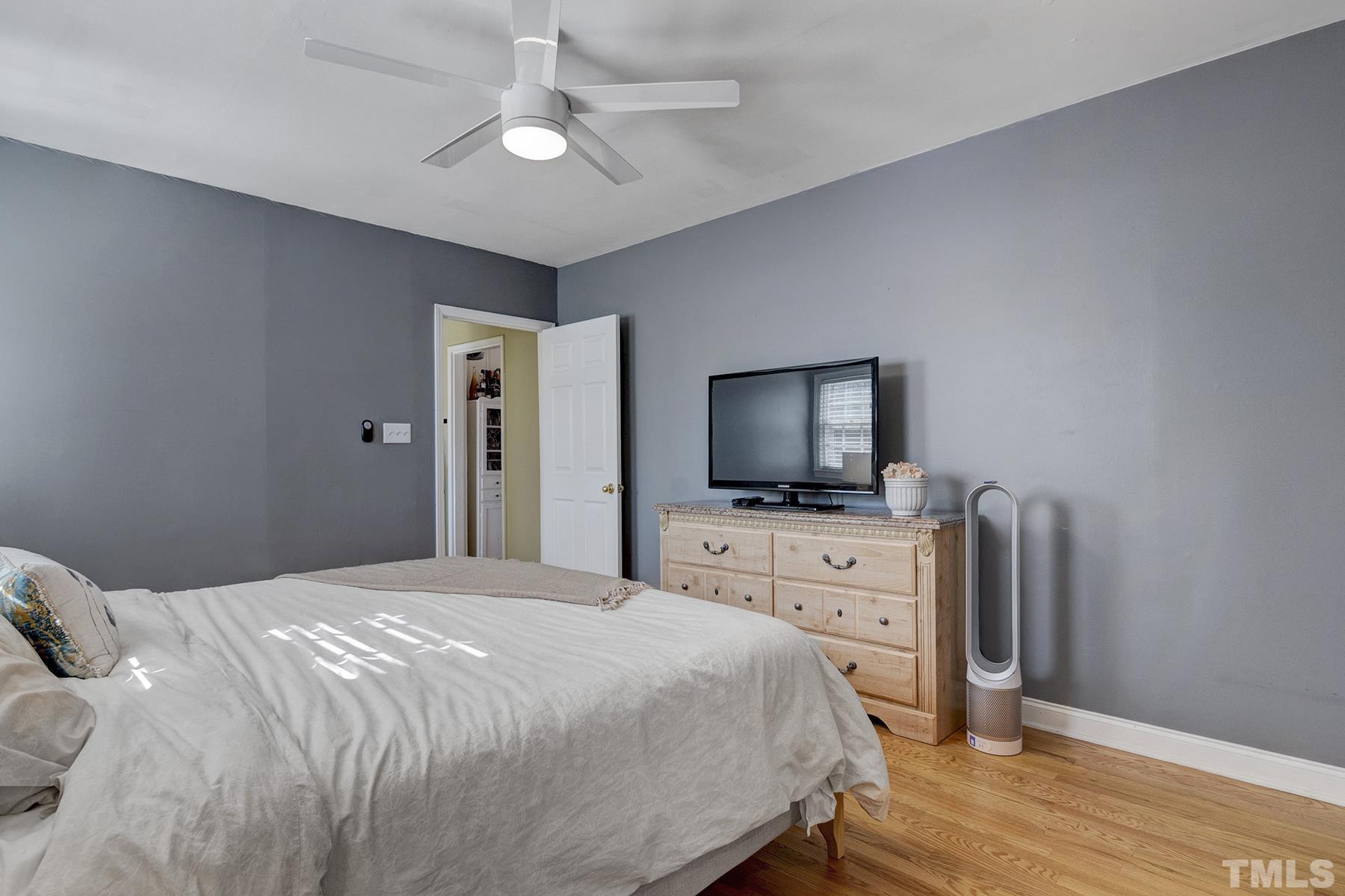 224 Glascock Street Raleigh, NC 27604 - Photo 18 of 28 a bedroom with a bed and a flat screen tv