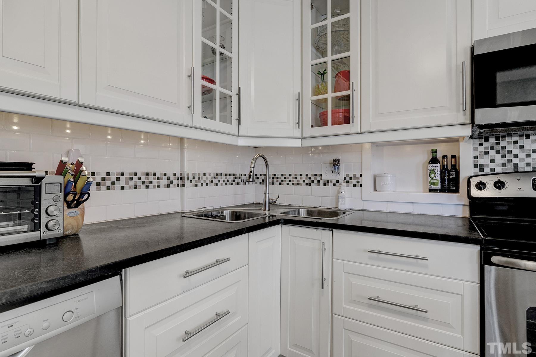224 Glascock Street Raleigh, NC 27604 - Photo 20 of 28 a kitchen with stainless steel appliances white cabinets and a sink