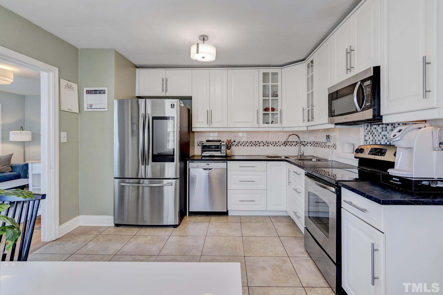 224 Glascock Street Raleigh, NC 27604 - Photo 26 of 28 a kitchen with a refrigerator stove and microwave