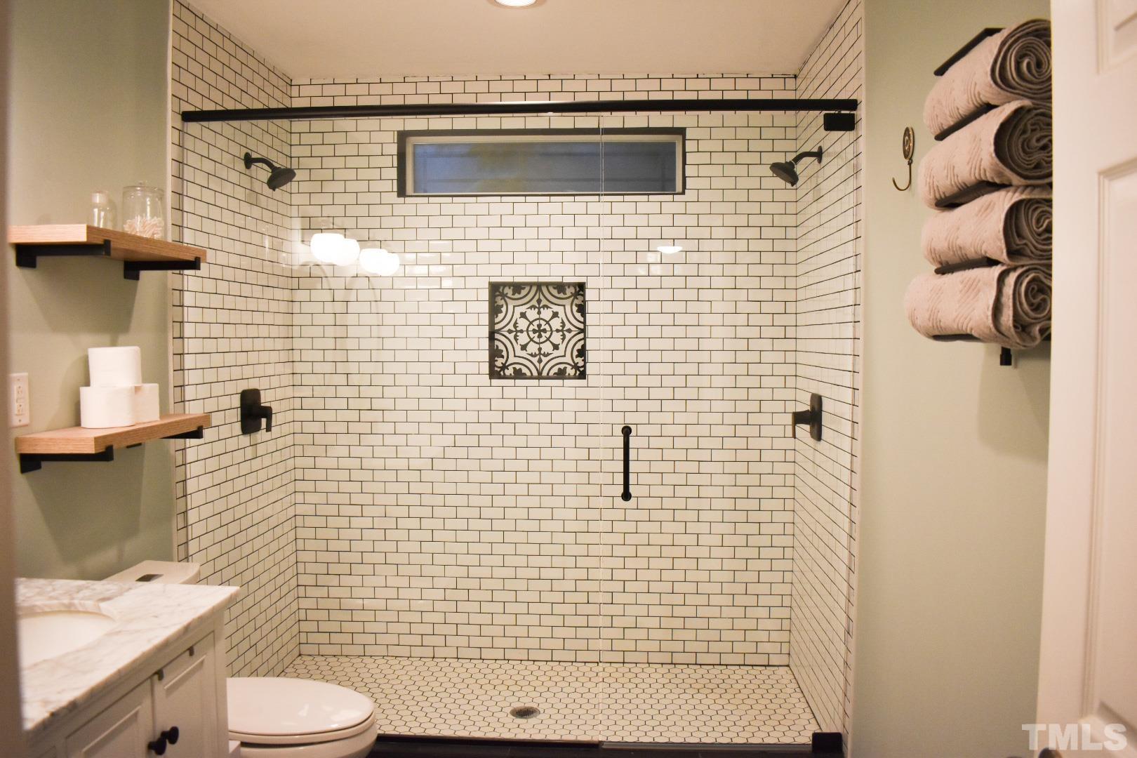 224 Glascock Street Raleigh, NC 27604 - Photo 3 of 28 a bathroom with a sink toilet and shower