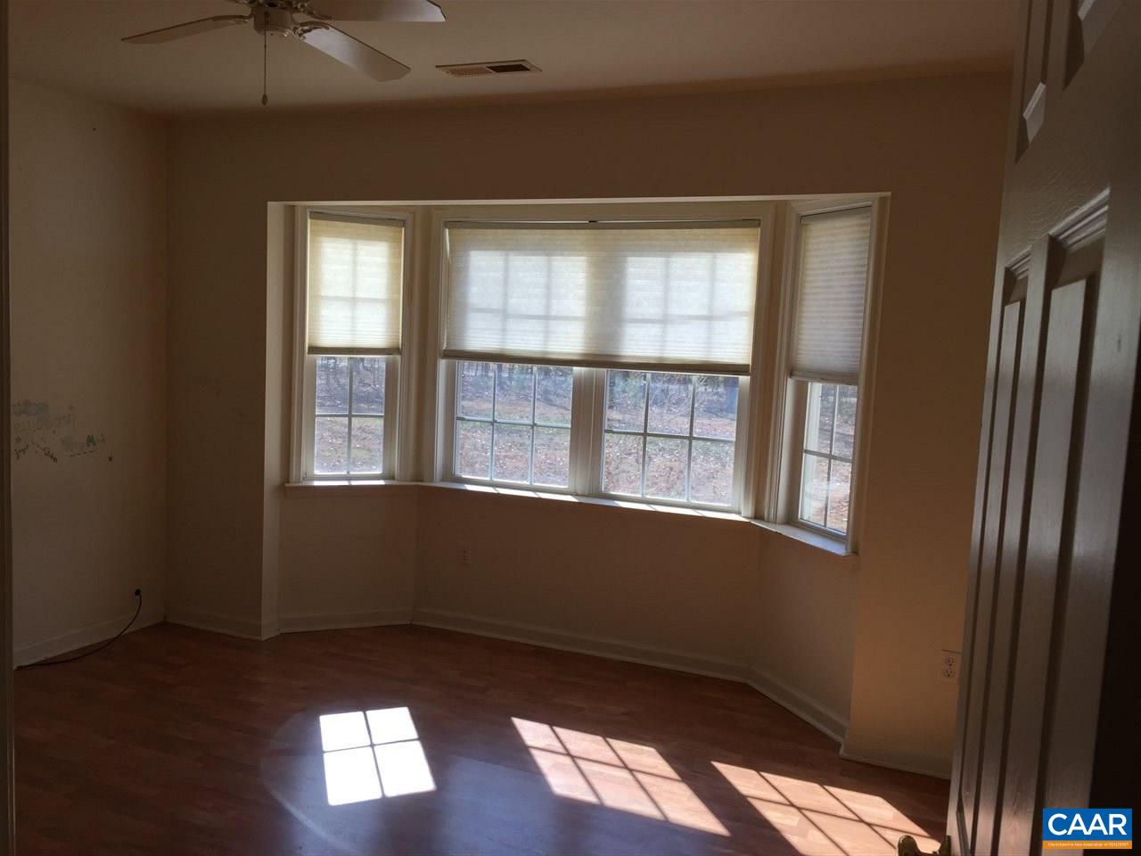 550 Walnut Shade Road Louisa, VA 23093 - Photo 17 of 28 a view of an empty room with wooden floor and a window
